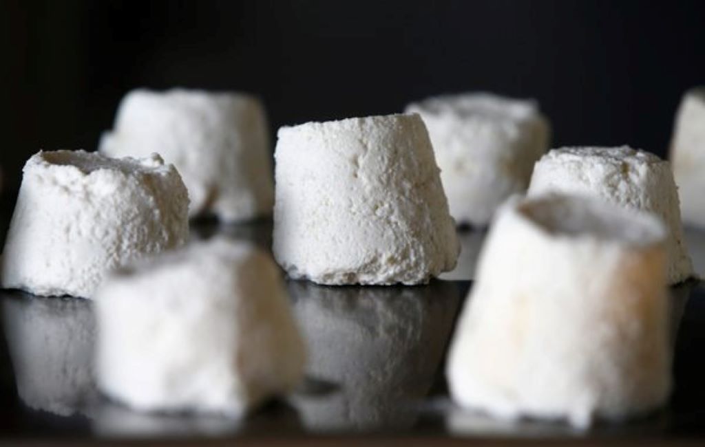 A close-up shot showing the dense, slightly porous texture of authentic Serbian Pule cheese